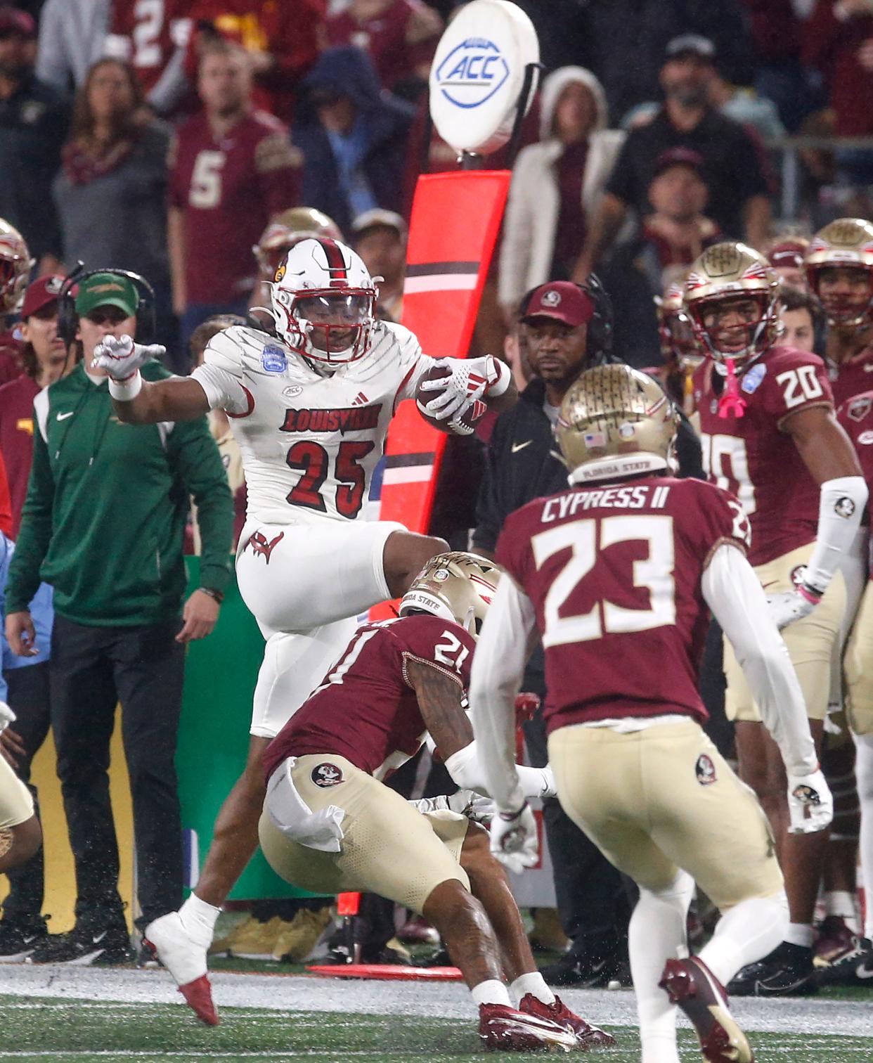 Louisville’s Jawhar Jordan makes a leap for a first down against Florida State’s Greedy Vance Jr.