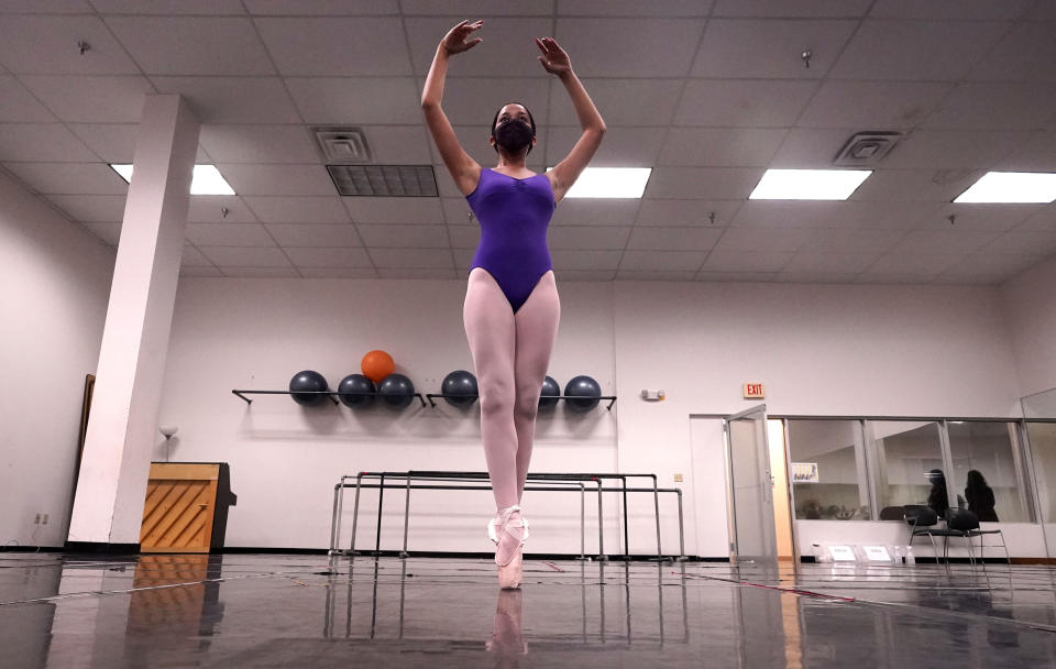 Ballet student Micah Sparrow dances in a classroom at the Texas Ballet Theatre, Wednesday, Oct. 7, 2020, in Fort Worth, Texas. For many, it's not Christmas without the dance of Clara, Uncle Drosselmeyer, the Sugar Plum Fairy, the Mouse King and, of course, the Nutcracker Prince. But this year the coronavirus pandemic has canceled performances of “The Nutcracker” around the U.S. and Canada, eliminating a major and reliable source of revenue for dance companies already reeling financially following the essential shutdown of their industry. (AP Photo/LM Otero)