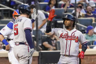 Atlanta Braves' Ozzie Albies, right, celebrates with Freddie Freeman after hitting a two-run home run during the second inning of the team's baseball game against the New York Mets, Tuesday, July 27, 2021, in New York. (AP Photo/Mary Altaffer)