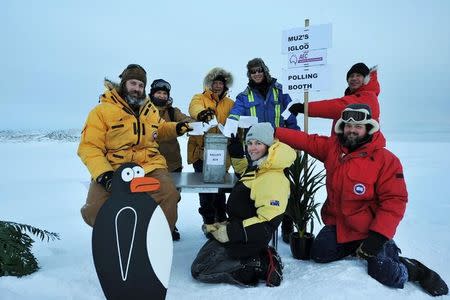 Voters stationed at the Casey Research Station in Antarctica pose with their ballots for the Australian federal election in this handout picture taken by Michael Brill of the Australian Antarctic Division, June 28, 2016. Australian Antarctic Division/Michael Brill/Handout via REUTERS