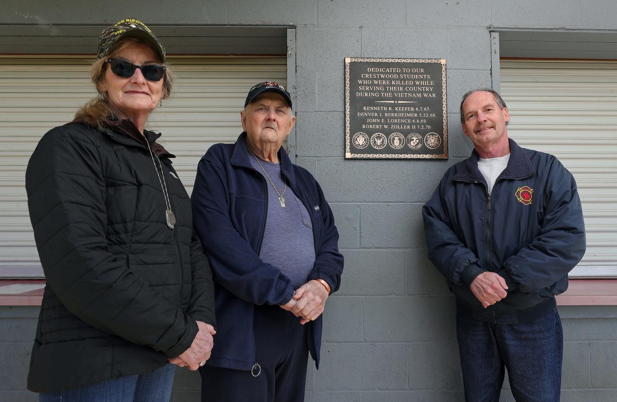 Bonnie Zoller-Collier, left, and her brother Bill Zoller, center, stand with Tim Benner in front of the new memorial plaque on the Crestwood High School fieldhouse honoring the four Crestwood students who gave their lives while serving during the Vietnam War, including Bonnie and Bill’s brother Robert Zoller. Benner, a local historian, helped get the ball rolling on the project when he discovered that the fieldhouse was supposed to memorialize the students when it was built in the early 1970s.