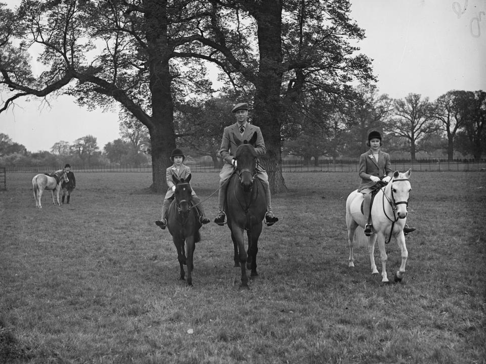 King George VI riding horse with his two daughters.