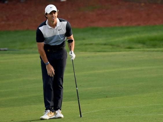 Rory McIlroy hits one of the shots of the season into the 18th (Getty)