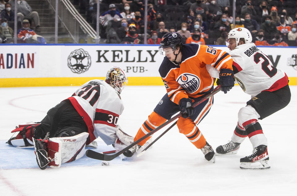 Ottawa Senators goalie Matt Murray (30) is scored on by Edmonton Oilers' Kailer Yamamoto (56) as Erik Brannstrom (26) defends during the second period of an NHL hockey game, Saturday, Jan. 15, 2022 in Edmonton, Alberta. (Jason Franson/The Canadian Press via AP)