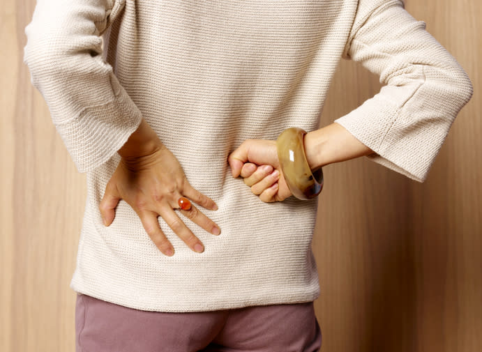 Person with back to camera, hands using sign language