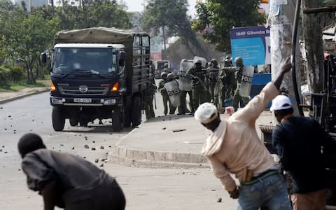 Supporters of Kenyan opposition National Super Alliance (NASA) coalition throw stones at police in Nairobi - Credit: BAZ RATNER/Reuters