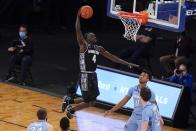 Georgetown's Chudier Bile (4) dunks the ball in front of Creighton's Ryan Kalkbrenner (32) and Antwann Jones (0) during the second half of an NCAA college basketball game in the championship of the Big East Conference tournament Saturday, March 13, 2021, in New York. (AP Photo/Frank Franklin II)