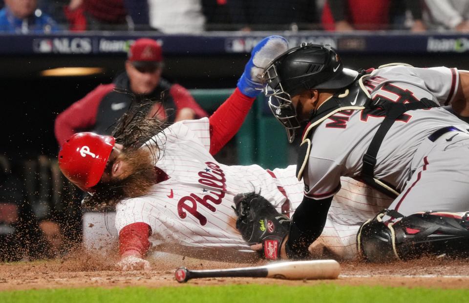 Philadelphia Phillies Brandon Marsh (16) is tagged out at home plate by Arizona Diamondbacks catcher Gabriel Moreno (14) in the 4th inning during Game 1 of the NLCS at Citizens Bank Park in Philadelphia on Oct. 16, 2023.