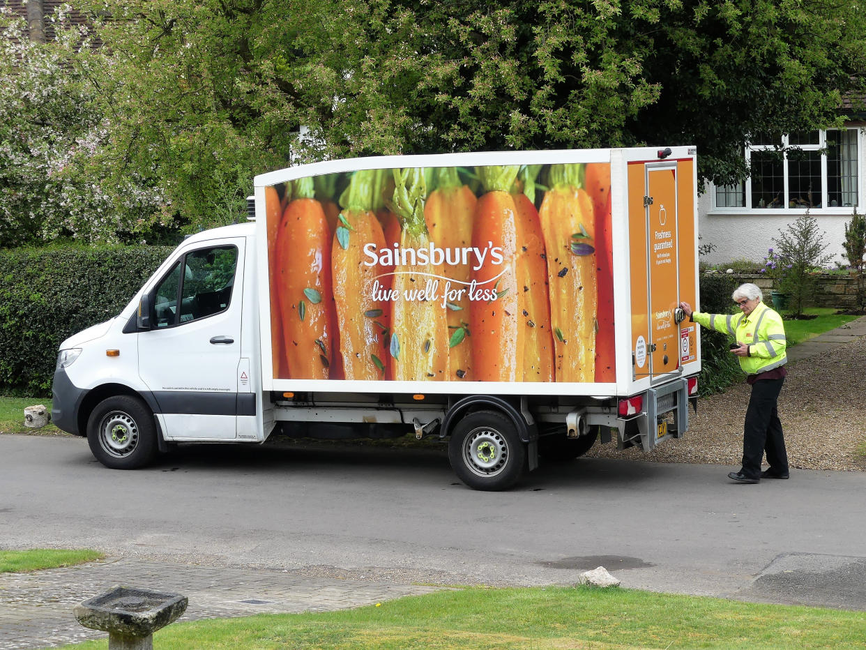 Chorleywood, Hertfordshire, England, UK - April 18th 2020: Sainsbury's home delivery van supplying groceries to elderly women during the Coronavirus (COVID-19) pandemic