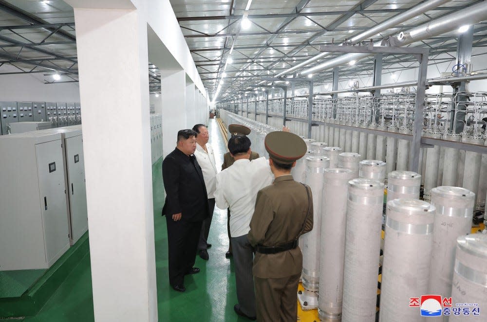 Kim Jong Un, left, is seen with military officials and scientists at a North Korean uranium-enrichment facility.