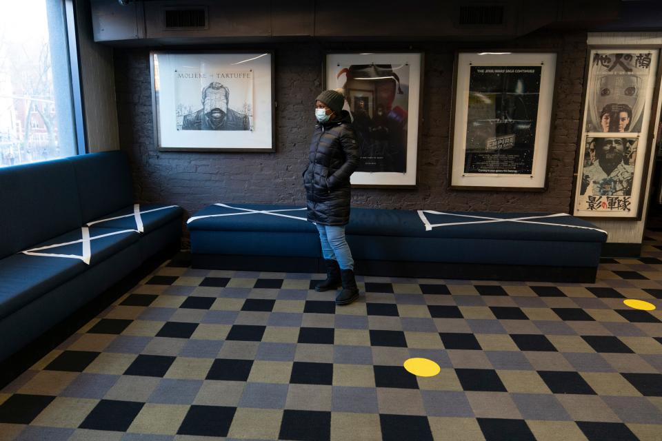 Tape on benches and dots on the floor mark the spacing for proper social distancing in a foyer at the IFC Center on March 5, 2021, in New York City.