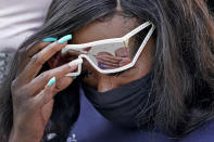 Deja Stallings wipes away tears during a news conference outside city hall Thursday, Oct. 8, 2020, in Kansas City, Mo. Protesters have occupied the lawn and plaza in front of city hall more than a week demanding the resignation of police chief Rick Smith and the officer who knelt on Stallings' back while arresting the pregnant woman last week. (AP Photo/Charlie Riedel)