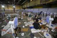 Laborers working to set up at COVID-19 field hospital in Mumbai, India, Thursday, April 22, 2021. New infections are rising faster in India than any other place in the world, stunning authorities and capsizing its fragile health system. (AP Photo/Rafiq Maqbool)