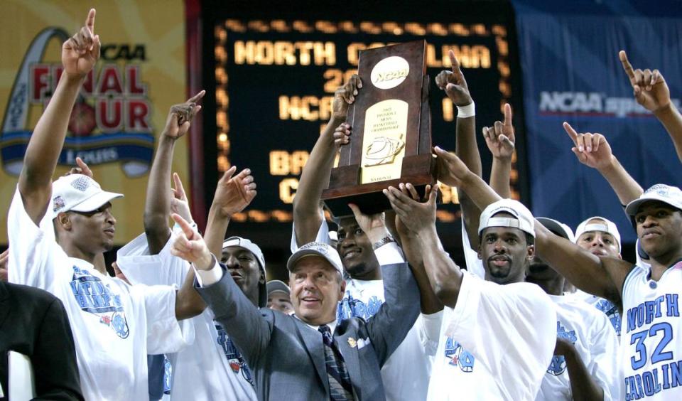 UNC players join Roy Williams in hoisting the NCAA tournament champion trophy after they defeated Illinois 75-70 in 2005.