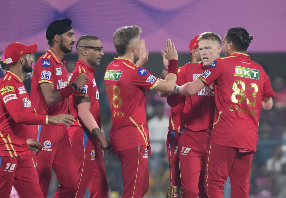 Punjab Kings celebrate the wicket of Rajasthan Royals's Jos Buttler during the Indian Premier League (IPL) 2023 match between Punjab Kings and Rajasthan Royals, in Guwahati, India, Wednesday, April 5, 2023. (AP Photo/Anupam Nath)