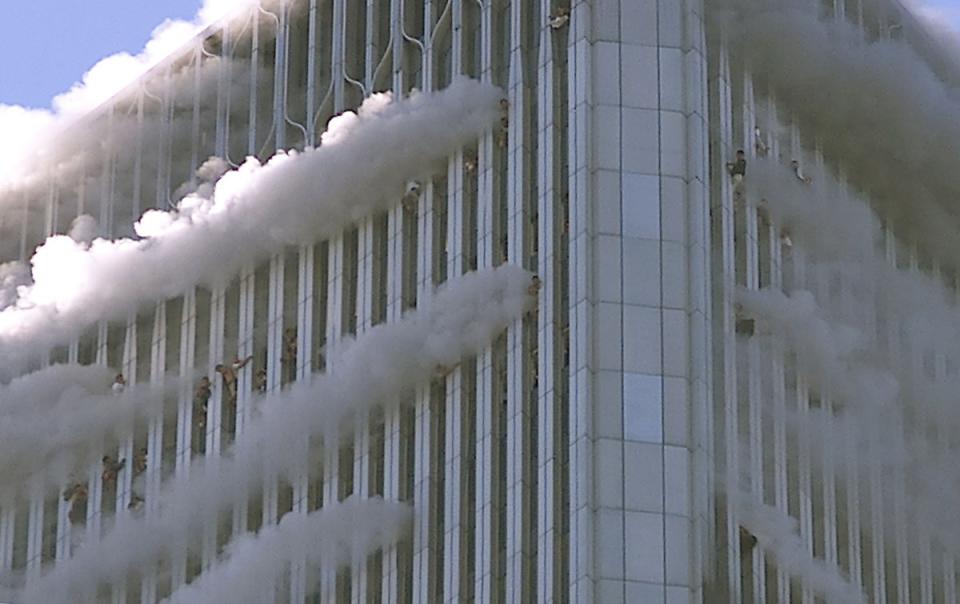 People hang from the windows of the North Tower (Primera Hora/Getty)