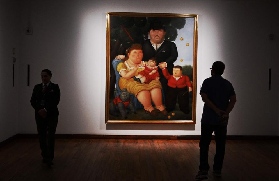 Security agents guard the Una Familia painting by Colombian artist Fernando Botero at the Botero Museum in Bogota on Sept. 15, 2023.