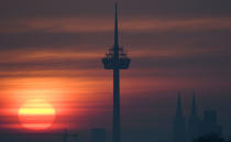 <p>The morning sun shines in bright colors through the mist as the Colonius television tower and Cologne appear as silhouettes in Cologne, Germany, Saturday, Feb. 25, 2017. (Henning Kaiser/dpa via AP) </p>