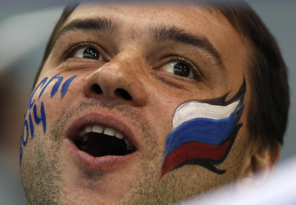 A Russian fan cheers during men's curling competition at the 2014 Winter Olympics, Monday, Feb. 10, 2014, in Sochi, Russia. (AP Photo/Robert F. Bukaty)