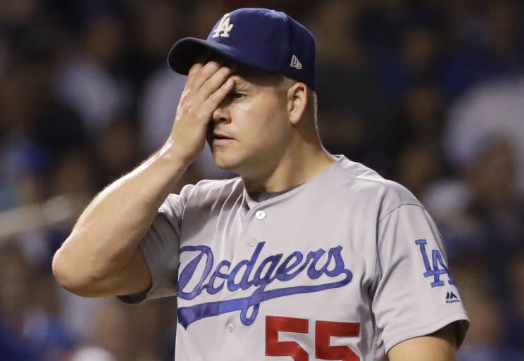 Joe Blanton reacts to an eighth-inning grand slam by Miguel Montero. (AP)