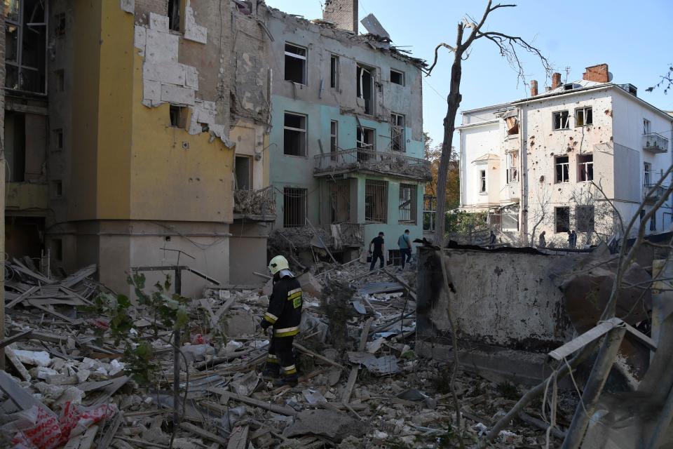 Rescuers search for victims in an apartment building destroyed by Russian missile attack in central Lviv (AP)