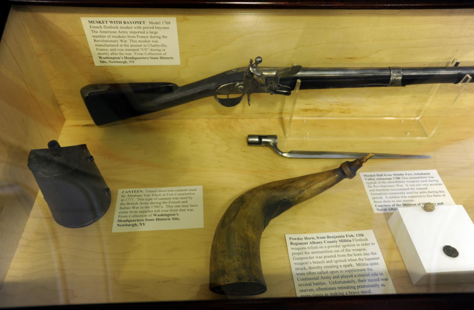 In this July 31, 2012 photo, weapons and a canteen from the Revolutionary and French and Indian wars sit on display at the Capitol in Albany, N.Y. Historic artifacts that have been kept in storage for years are now on display in the corridors of the Capitol and the adjacent Empire State Plaza. (AP Photo/Tim Roske)