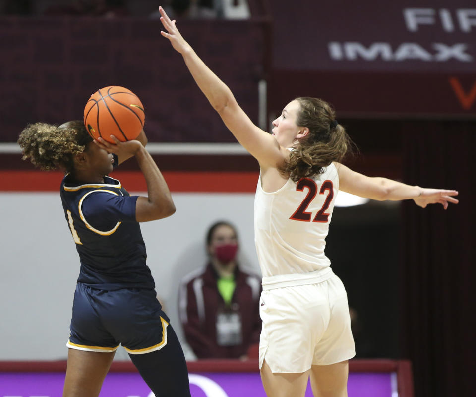 Coppin State's Mossi Staples (1) attempts to shoot Virginia Tech's Cayla King (22) defends during in the first half of an NCAA college basketball game in Blacksburg Va., Wednesday, Nov. 17 2021. (Matt Gentry/The Roanoke Times via AP)