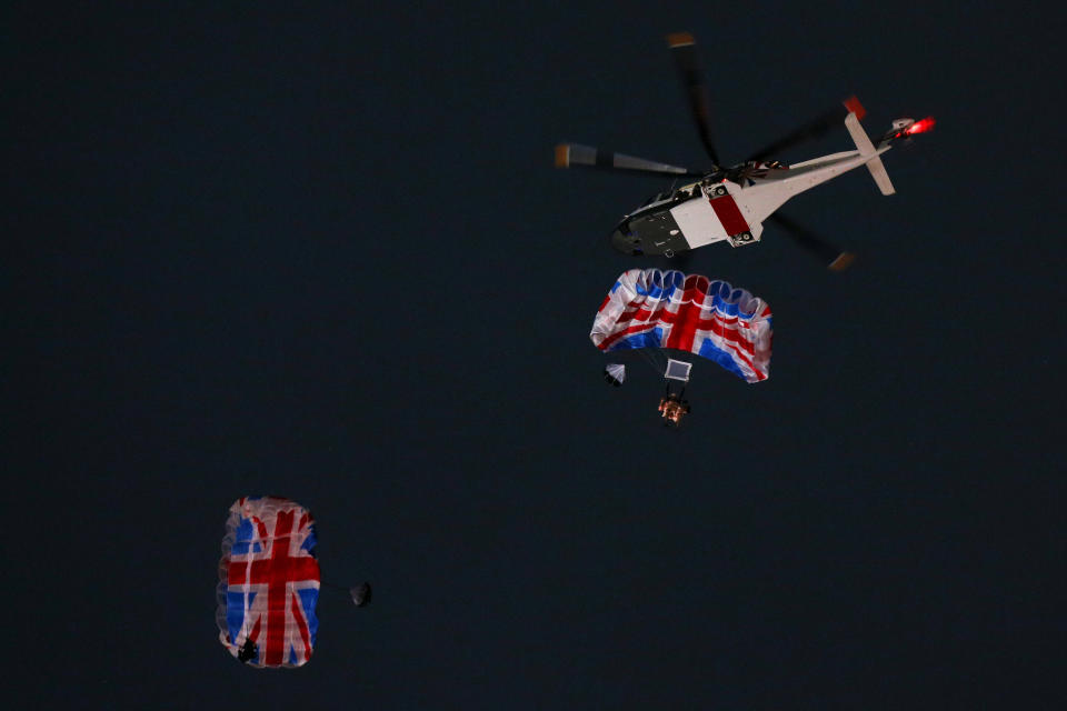 LONDON, ENGLAND - JULY 27:  Gary Connery and Mark Sutton parachute into the stadium as part of short James Bond film featuring Daniel Craig and The Queen during the Opening Ceremony of the London 2012 Olympic Games at the Olympic Stadium on July 27, 2012 in London, England.  (Photo by Cameron Spencer/Getty Images)