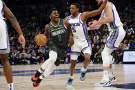 Minnesota Timberwolves guard Anthony Edwards (1) is fouled by Sacramento Kings guard De'Aaron Fox during the first half of an NBA basketball game Saturday, Jan. 28, 2023, in Minneapolis. (AP Photo/Craig Lassig)