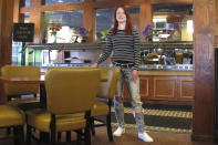 In this March 25, 2020 photo, Courtney Keith poses for a photo in the Glendale Garden Café in Toledo, Ohio. Keith, who has spent four years in drug and alcohol addiction recovery, lost her job as a waitress there when Ohio banned sit-down dining to combat the coronavirus. She's concerned that others could relapse because of the heightened anxiety over the outbreak. (AP Photo/John Seewer)