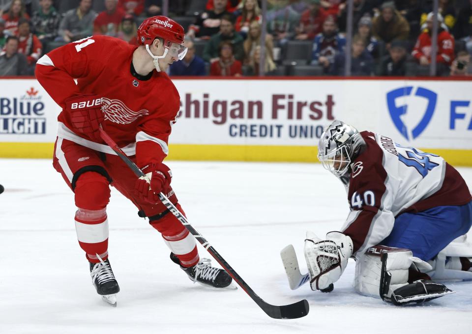 Detroit Red Wings left wing Dominik Kubalik, left, has his shot stopped by Colorado Avalanche goaltender Alexandar Georgiev (40) during the third period of an NHL hockey game Saturday, March 18, 2023, in Detroit. (AP Photo/Duane Burleson)
