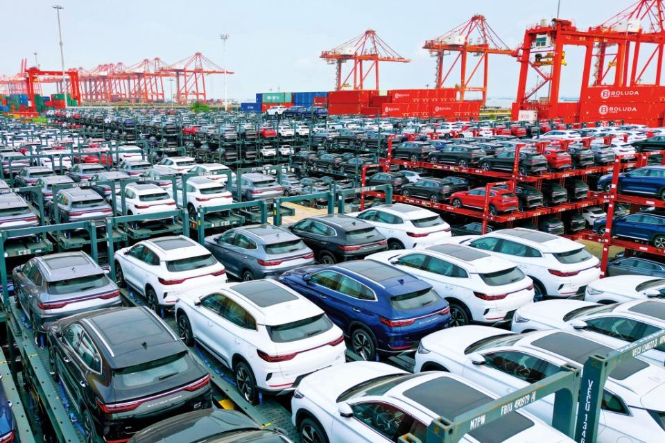 ELECTRIC SUPERPOWER Electric vehicles made by China’s BYD wait at a port in Suzhou, China, to be shipped abroad. Government subsidies of its manufacturing capacity have helped put BYD on track to become the world’s top seller of EVs.