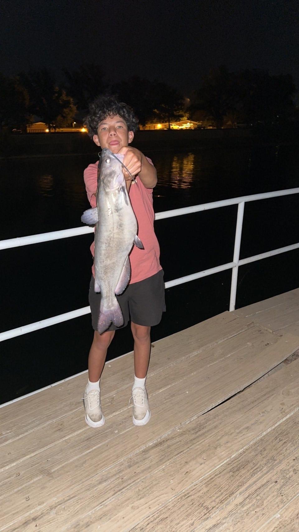 Bradlee Granger shows off a 16-pound channel catfish caught June 25, 2023 in Carlsbad.