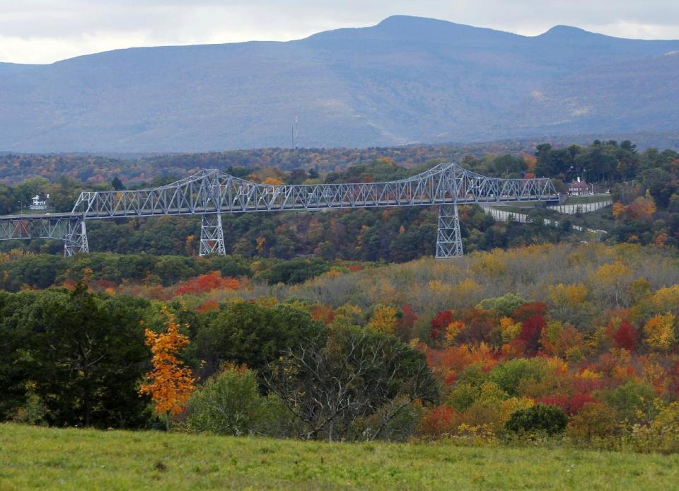 FILE - This Oct. 19, 2010 file photo shows the Rip Van Winkle Bridge, which spans the Hudson River amid autumn colors in Greenport, N.Y. The Hudson Valley region offers many free things to see and do, including beautiful scenery from the river and surrounding mountains and towns. (AP Photo/Mike Groll, File)