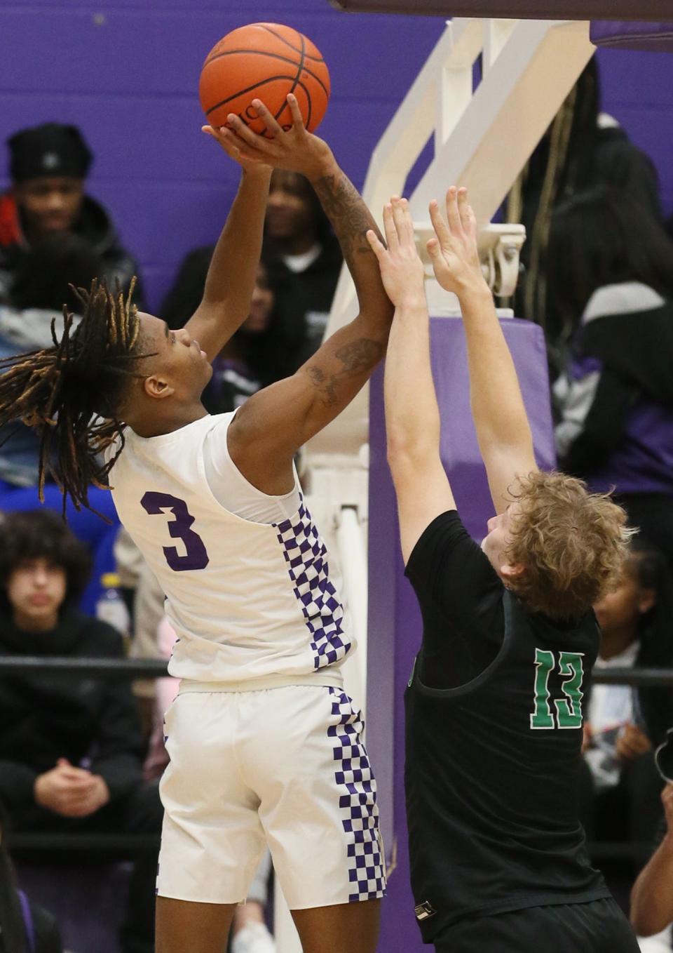Barberton's De'Arion Holley shoots over Highland's Hunter Winston in a key Suburban League matchup won by the Magics.