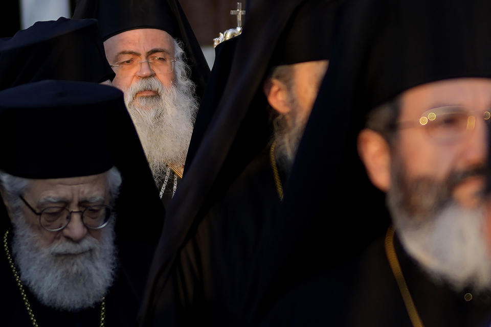 The head of Cyprus' Orthodox Church Archbishop Georgios, rear, walks with other bishops during his enthronement ceremony at Saint Barnabas Cathedral in capital Nicosia, Cyprus, Sunday, Jan. 8, 2023. Archbishop Georgios formally assumed his new duties following an enthronement ceremony evoking the splendor of centuries of Byzantine tradition before an audience of Orthodox clergy from around the world with the notable exception of the Russian church. The Cyprus Church has recognized the independence of the Orthodox Church of Ukraine. (AP Photo/Petros Karadjias)