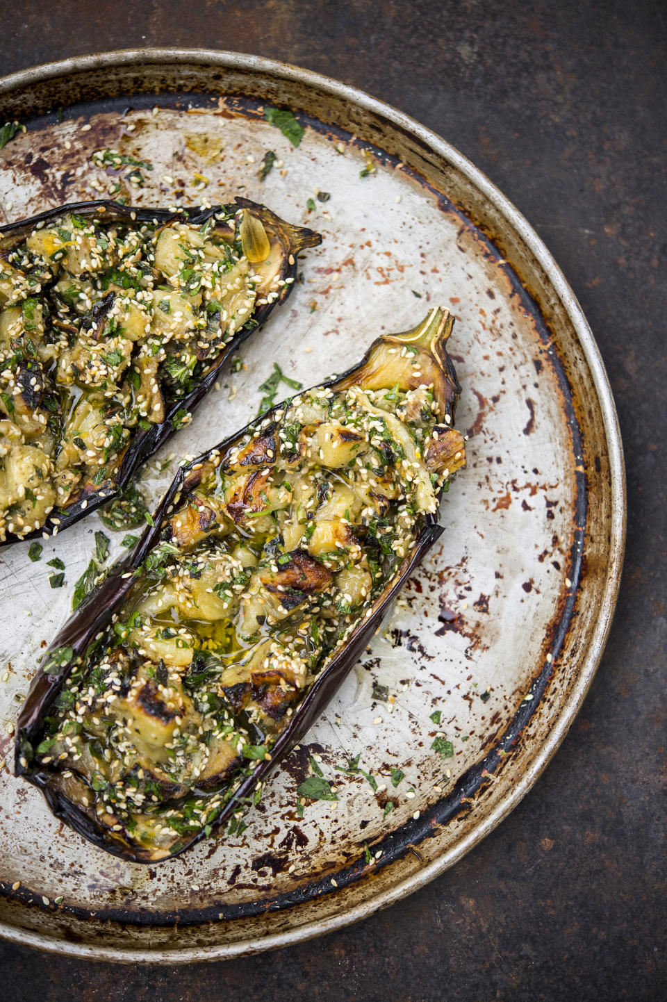 This image released by Milk Street shows a recipe for grilled eggplant with sesame and herbs. (Milk Street via AP)