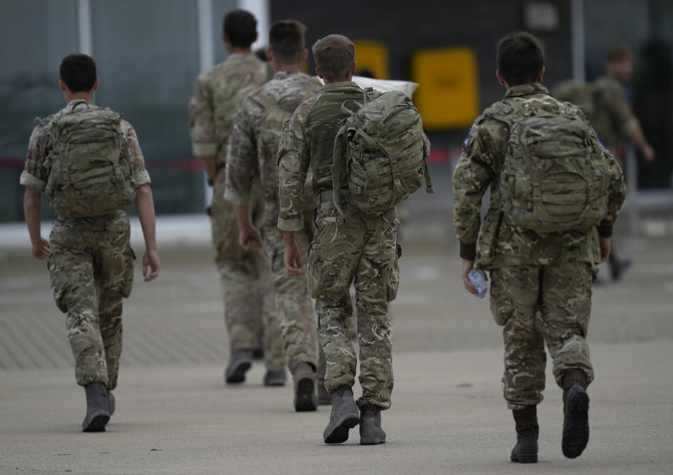 Members of the British armed forces 16 Air Assault Brigade walk to the air terminal after disembarking a RAF Voyager aircraft at Brize Norton, England, as they return from helping in operations to evacuate people from Kabul airport in Afghanistan, Saturday, Aug. 28, 2021. More than 100,000 people have been safely evacuated through the Kabul airport, according to the U.S., but thousands more are struggling to leave in one of history's biggest airlifts. (AP Photo/Alastair Grant, Pool)