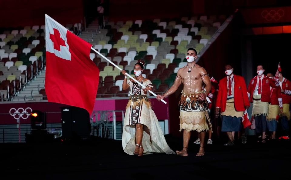 Tonga flag bearers Malia Paseka and Pita Taufatofua during the opening ceremony for the Tokyo 2020 Olympic Summer Games at Olympic Stadium. Rising athlete J.J. Rice, set to complete for Tonga in Kite Foiling at the Paris 2024 Olympic Summer games, died in a diving accident on June 15, 2024.