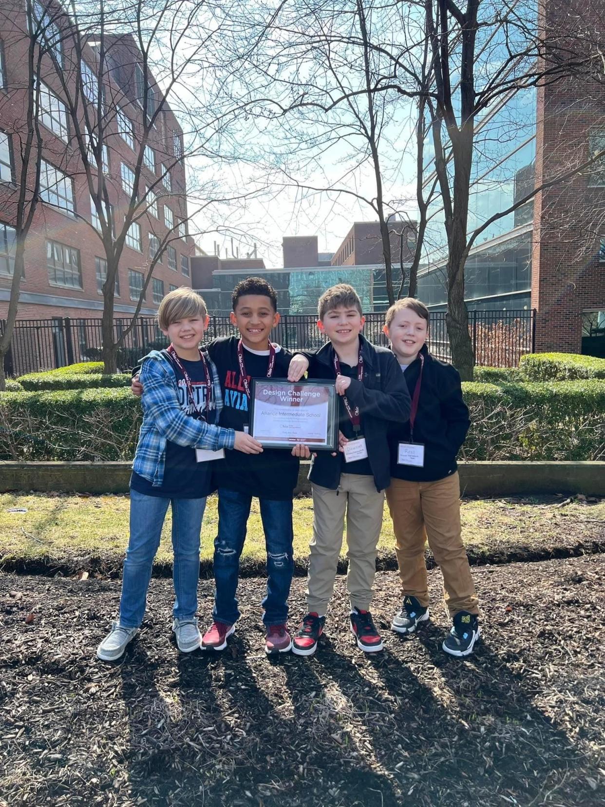 Showing off a certificate they won as the elementary-level champion in the Ohio STEM Learning Network #STEMorbitsOhio design challenge are, from left, competitors Andrew Horning, Talen Henderson, Dawson Sedei and Ross Gardner of Alliance Intermediate School.