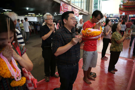 "Drag Race Thailand" contestant Assadayut Khunviseadpong 'Natalia Pliacam' (2nd L) prays at a Chinese shrine in Bangkok, Thailand March 18, 2018. REUTERS/Athit Perawongmetha