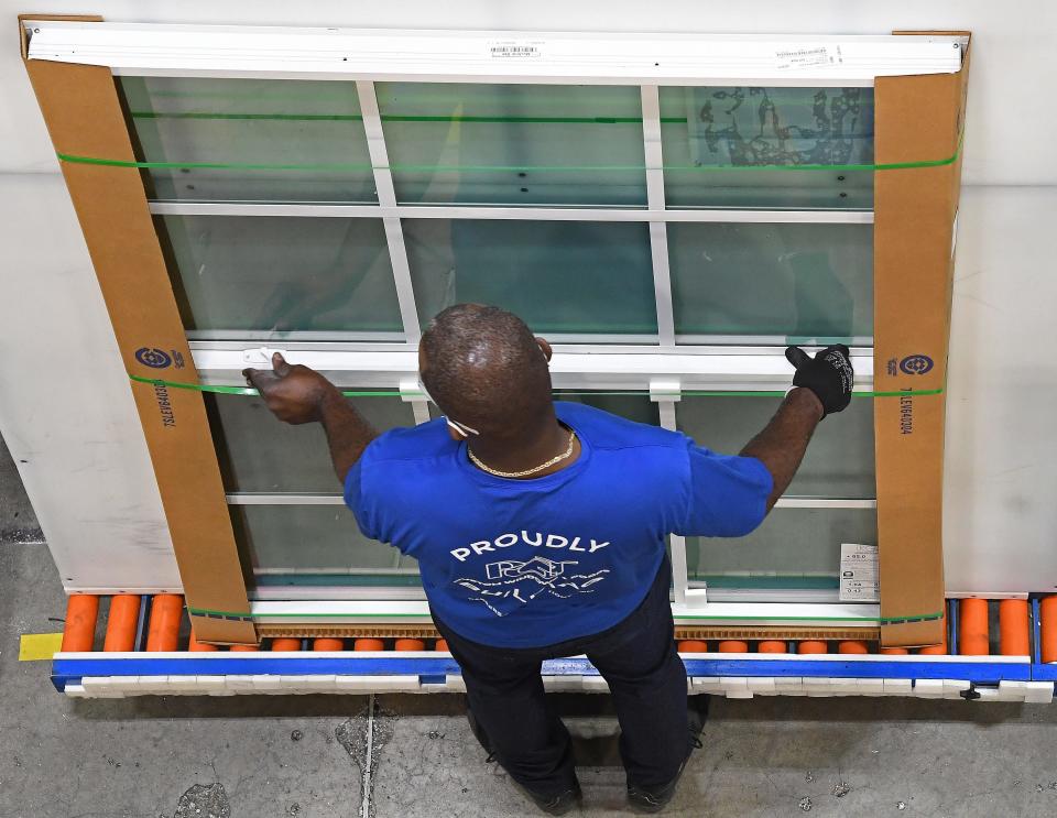 A PGT Innovations employee inspects single-hung windows at the plant in North Venice. PGT is the largest employer in Sarasota County.