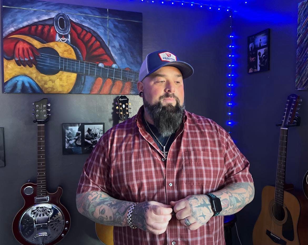 Aaron Hymes, a Christian country music artist, is shown at his Stark County home, where he rehearses and records music with his band.