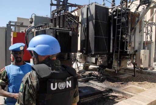 A picture from state-run Syrian Arab News Agency shows UN observers visiting a power transfer station in the Qabun district of Damascus. The Syrian army killed at least 26 civilians on Saturday, a watchdog said, as a global outcry mounted over yet another massacre in the country, but with Russia stressing that it will block any UN use of force against its ally