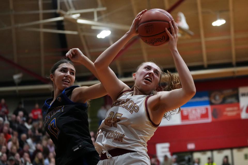 Watterson's Cameron Sparks (25) spins around Olentangy's Katie Heyd (13) during Tuesday night's regional semifinal.