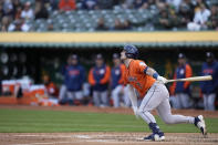 Houston Astros' Alex Bregman watches his RBI-single against the Oakland Athletics during the third inning of a baseball game in Oakland, Calif., Friday, May 26, 2023. (AP Photo/Godofredo A. Vásquez)