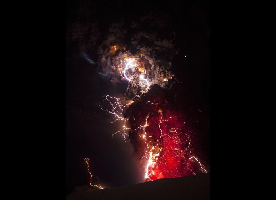 Lightning is seen within a cloud of volcanic matter as it rises from the erupting Eyjafjallajokull volcano April 20, 2010 Eyjafjallajokull, Iceland. A major eruption occurred on April 14, 2010 which has resulted in a plume of volcanic ash being thrown into the atmosphere over parts of Northern Europe. Air traffic has been subject to cancellation or delays, as airspace across parts of Northern Europe has been closed.  (Photo by Terje Sorgjerd/Getty Images)