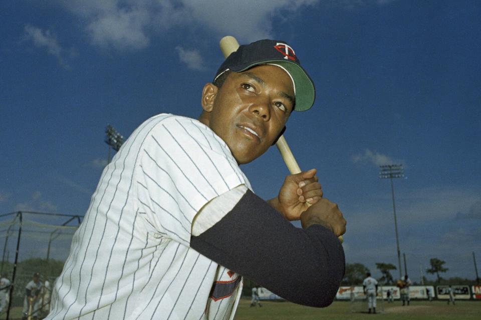 A man poses with a baseball bat