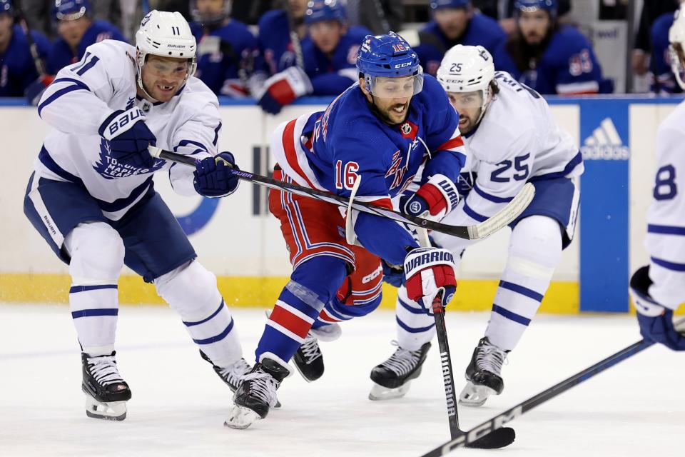 Dec 12, 2023; New York, New York, USA; New York Rangers center Vincent Trocheck (16) skates with the puck against Toronto Maple Leafs center Max Domi (11) and defenseman Conor Timmins (25) during the second period at Madison Square Garden.
