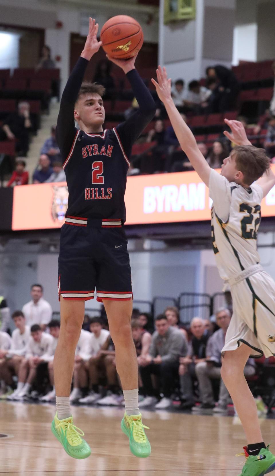 Byram Hills' Tyson Repa shoots over Hastings' Dylan Heilakka during a Class B semifinal at the Westchester County Center Feb. 27, 2023. Byram Hills won 54-32